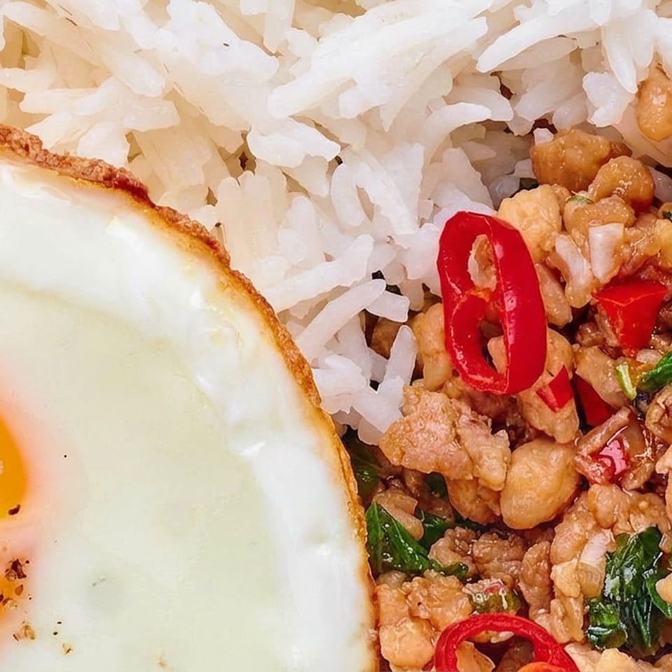 Thai-style minced meat with basil and red chilies served over rice, topped with a fried egg.